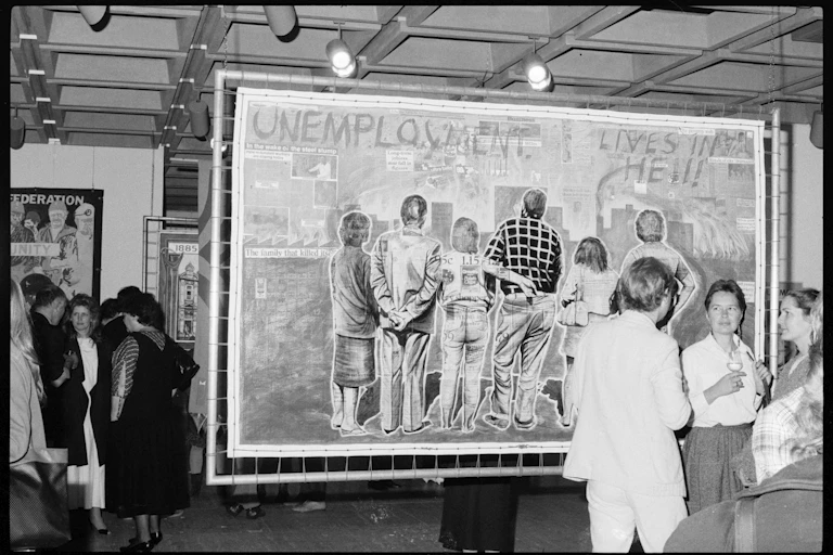 A poster reads 'unemployment lives in hell'.