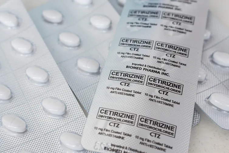 Multiple blister packs of antihistamine medication.