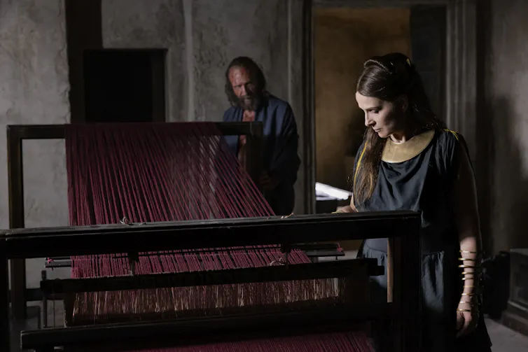 Penelope with her loom and Odysseus looking on.