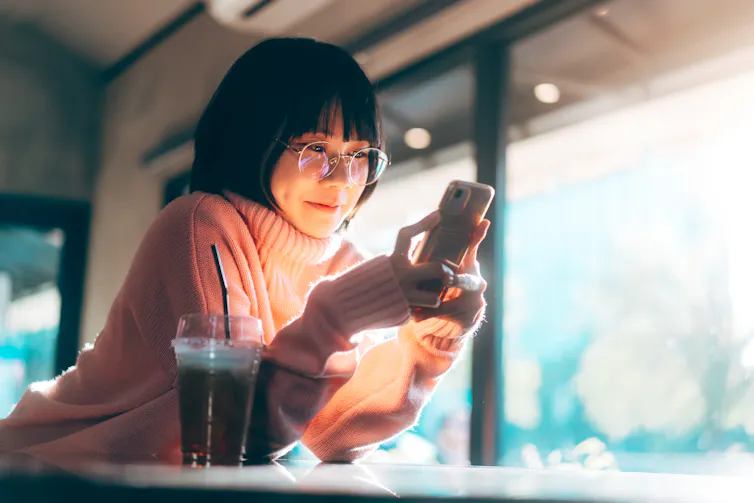 Woman smiling at her phone