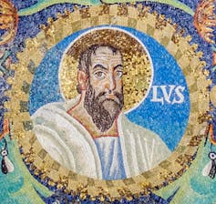 A colorful mosaic centers on the face of a bearded man with a golden halo behind him.