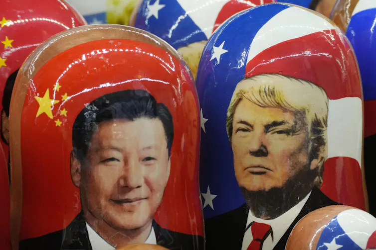 The images of two men are seen on wooden dolls.