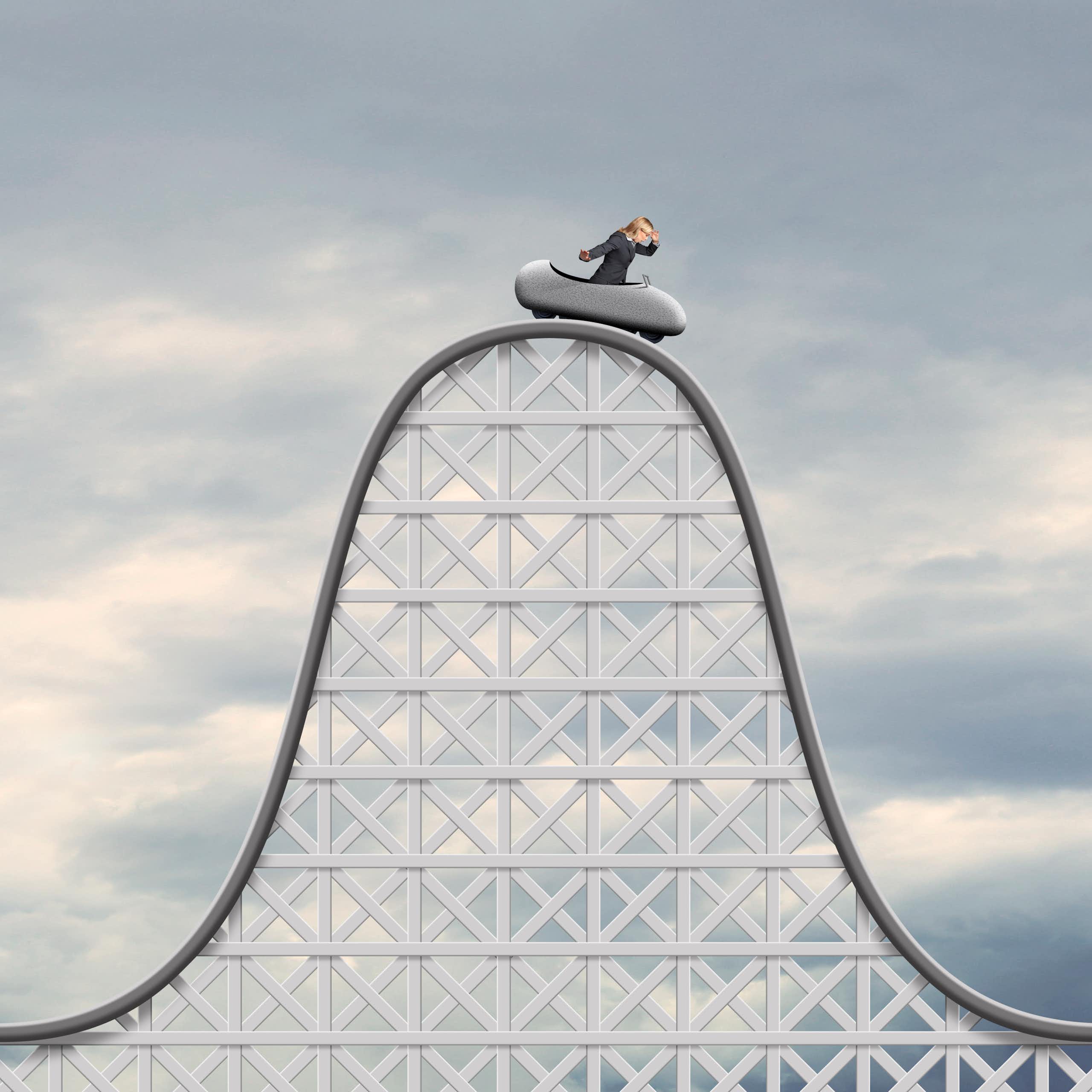 An image shows a figure on the top of a roller coaster.