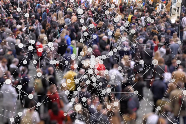 Coronavirus particles spreading in a crowd of people.
