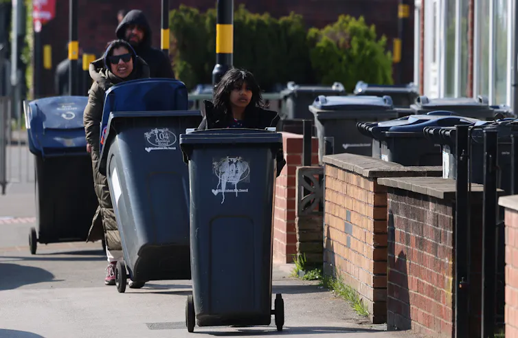 Birmingham residents taking their bins to a drop-off point.