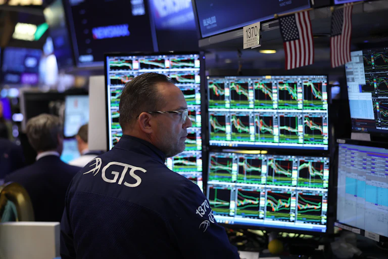 anxious trader looking at market responses after donald trump's tariffs announcement.