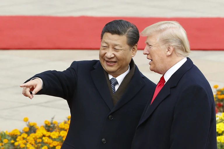 Two men in suits stand and point.