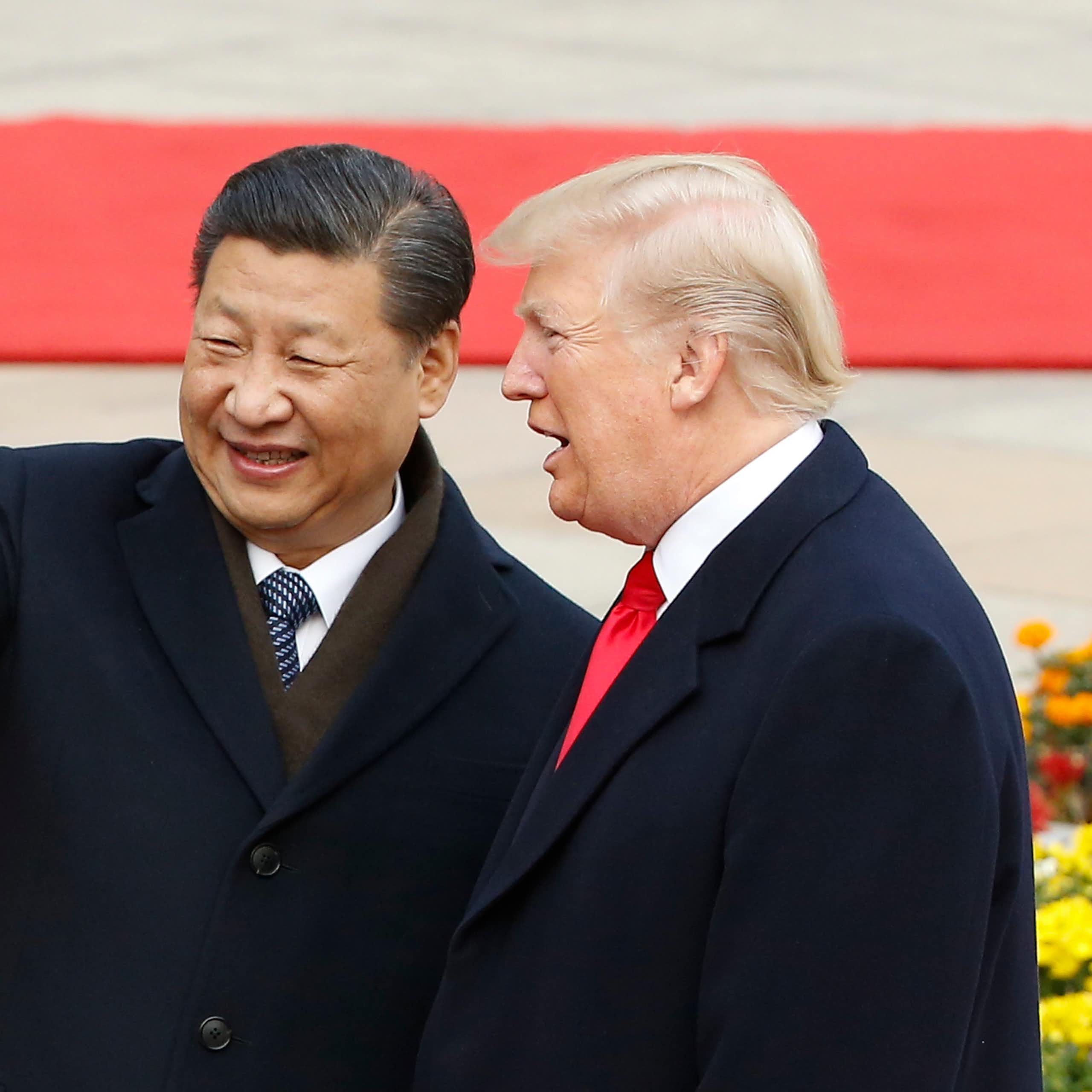 Two men in suits stand and point.