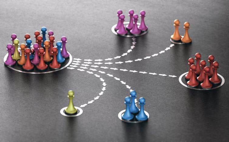 clumps of differently colored game pawns are separated into smaller groups by color