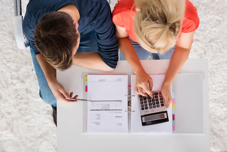Overhead shot of man and woman going through their finances