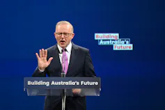 Man speaking at a lectern