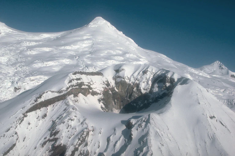 A volcano and the crater where Mount Spurr has erupted in the past.