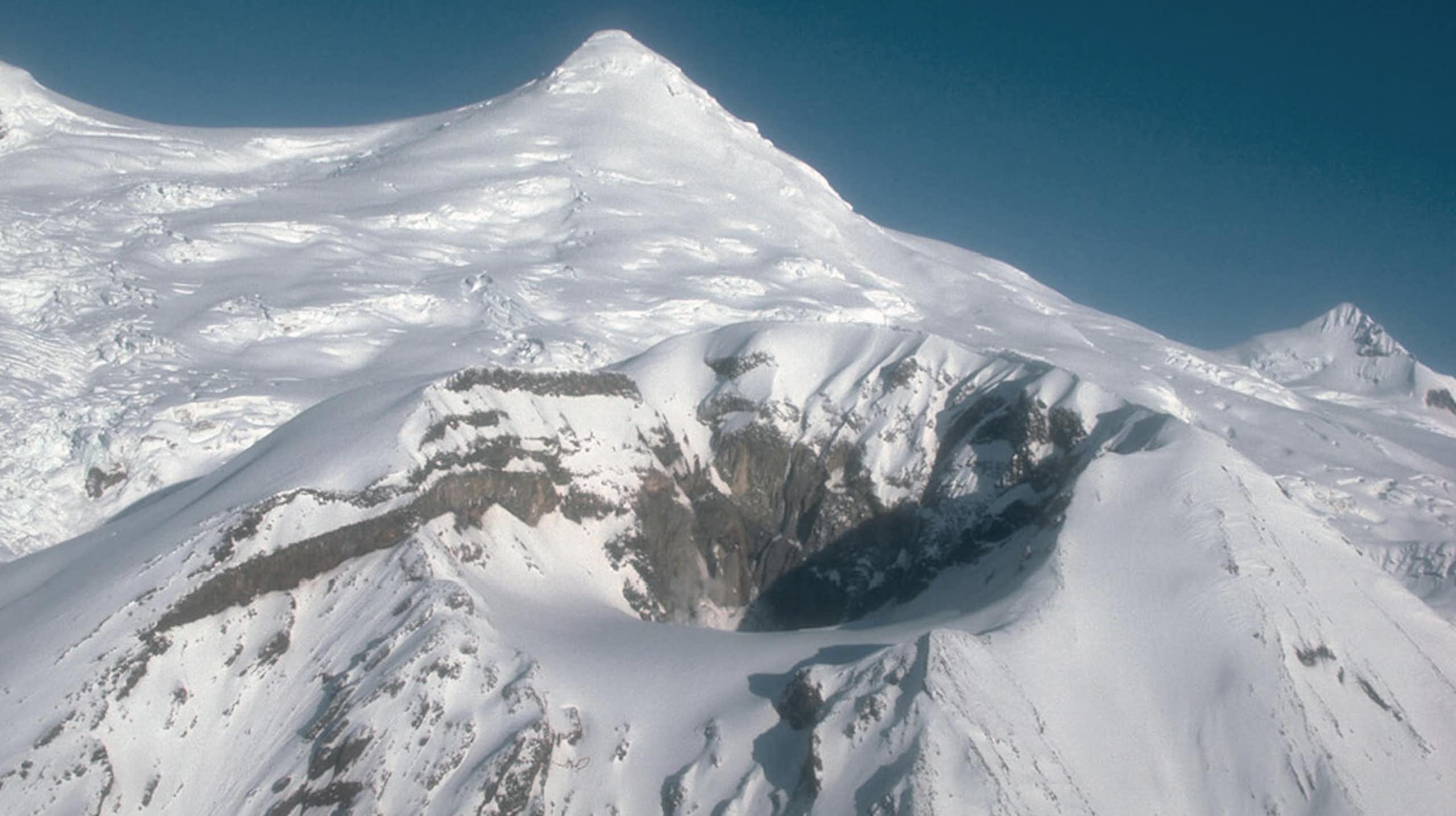 A volcano and the crater where Mount Spurr has erupted in the past.