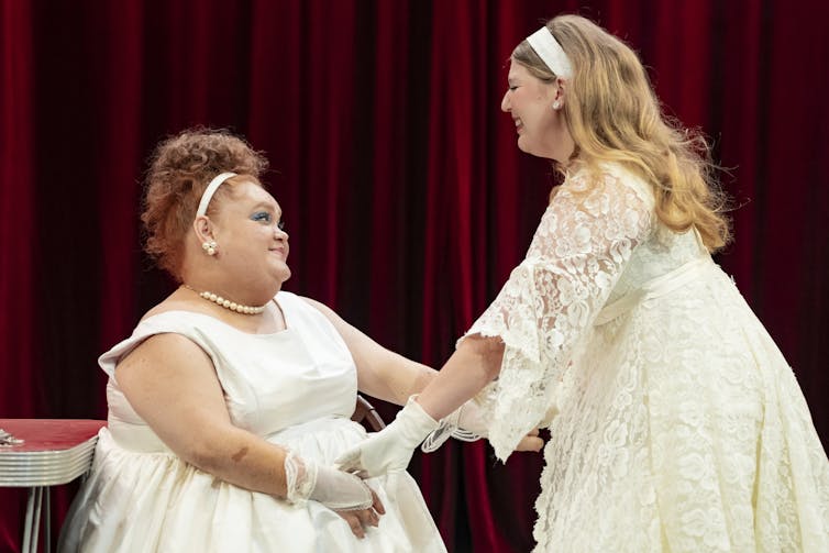 Production image: two young women in white.