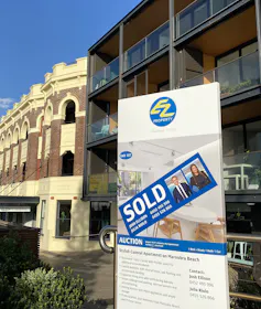 For sale sale sign in front of a block of apartments in Maroubra, Sydney