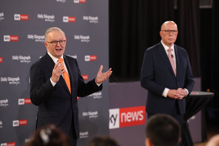 Anthony Albanese and Peter Dutton stand and speak to an audience.