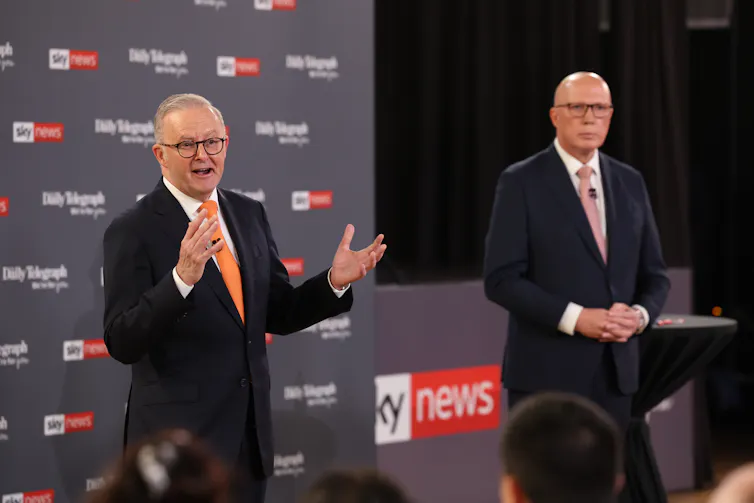 Anthony Albanese and Peter Dutton stand and speak to an audience.
