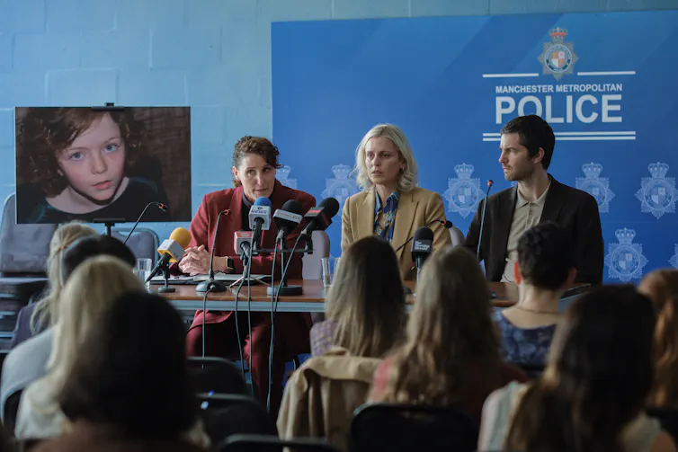 Parents sit in a police press conference