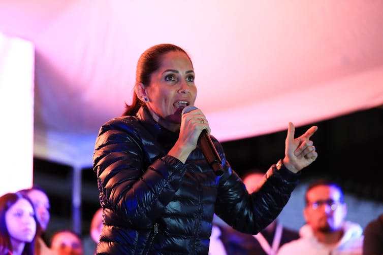 Luisa González speaking into a microphone.