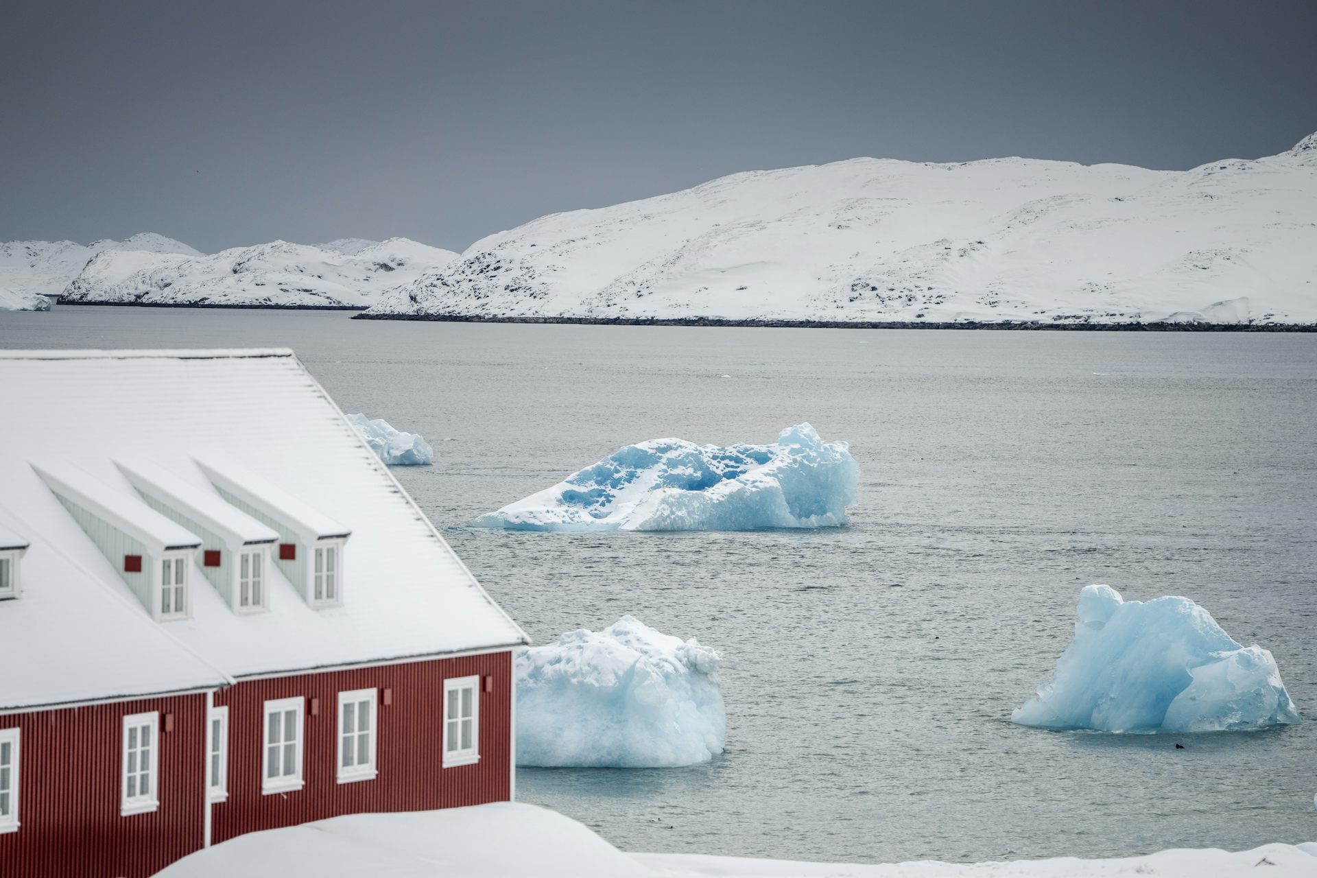 Large pieces of ice float past a church in Nuuk, Greenland.