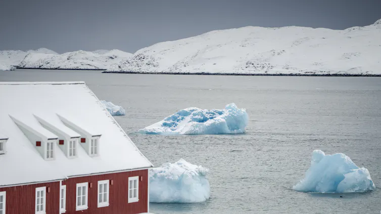 Large pieces of ice float past a church in Nuuk, Greenland.
