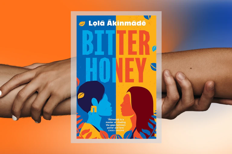 Two hands shaking behind the jacket of the novel