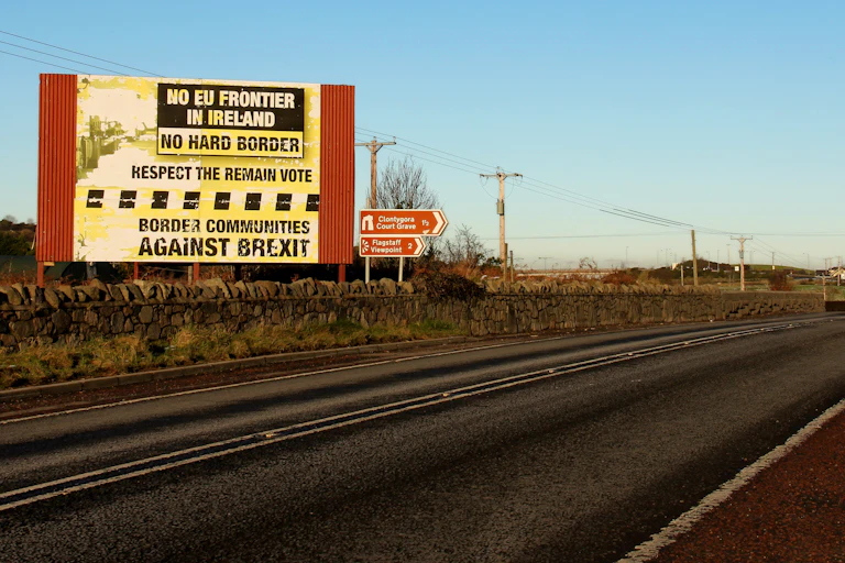 A roadside sign in Northern Ireland reading 'No EU frontier in Ireland, no hard border, respect the remain vote, border communities against Brexit'