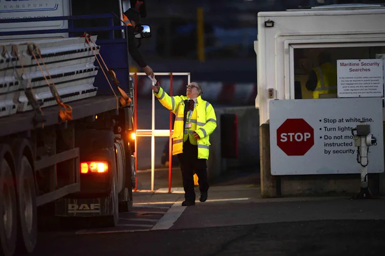 An officer carries out checks on trucks at Larne Port ferry terminal in Northern Ireland