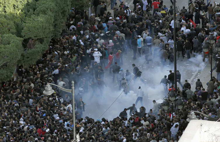 Clouds of tear gas among a group of protesters.
