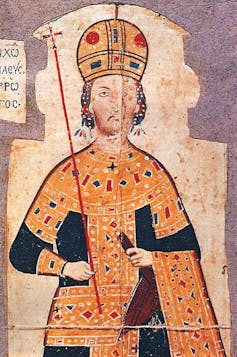 A painting of a bearded man wearing a jewle-encrusted hat.