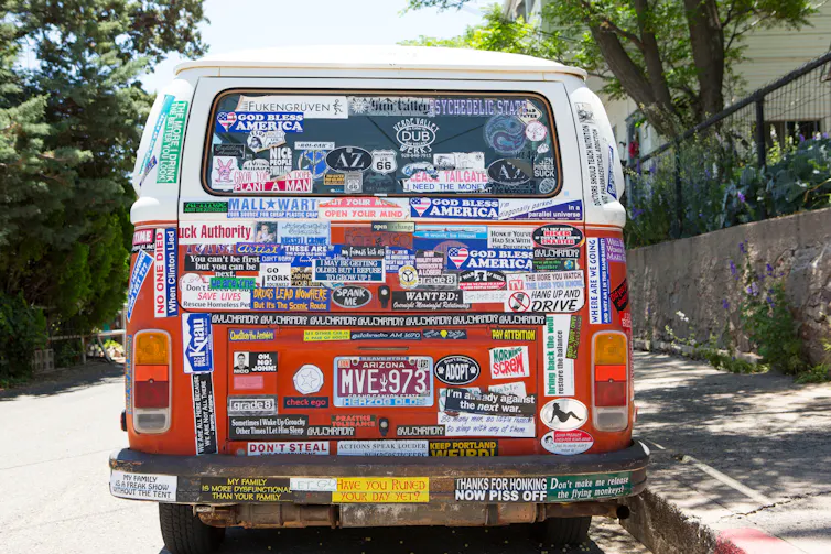Rear of a van covered with bumber stickers