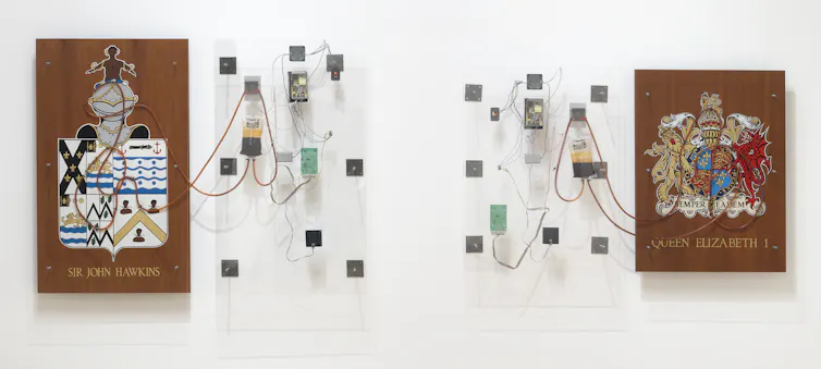 Perspex, wood, silicon tubing, gold leaf, plastic bags and electrical pump hang on a wall.