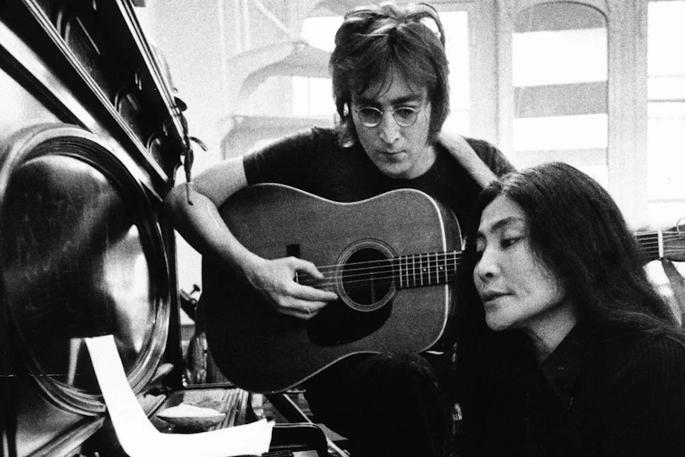 Ono playing piano and Lennon playing guitar