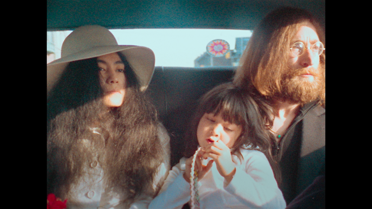 Lennon and Ono in a taxi with a child
