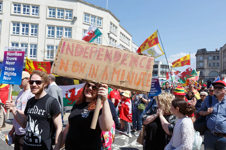 A Welsh independence march including a woman holding a sign saying "independence now in a minute".