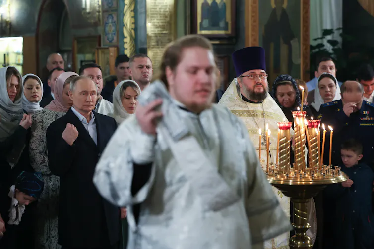 Putin attends a Christmas service in a church.