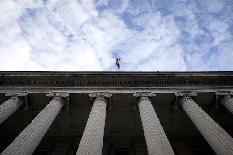 Neoclassical architecture of the U.S. Treasury Department is seen from below.