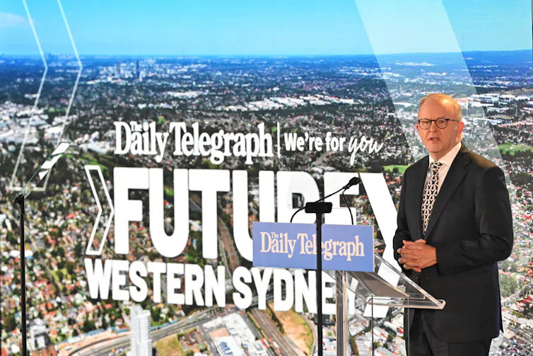 Anthony Albanese stands at a podium in front of a background that says future of western sydney