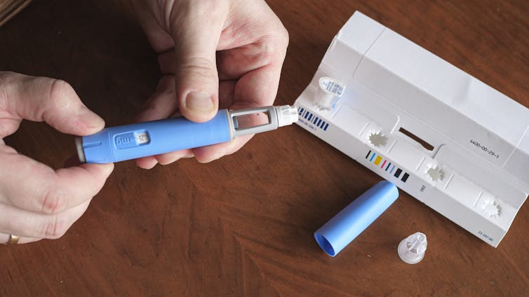 A person preparing a semaglutide injection.