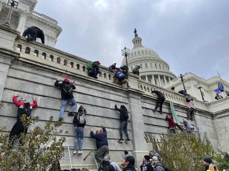 protesters scaling walls of Capitol building