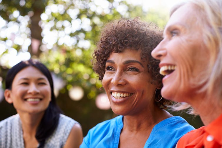 Three women smiling.