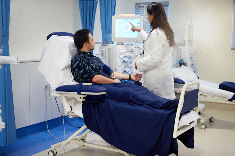 Man receiving kidney dialysis in hospital.