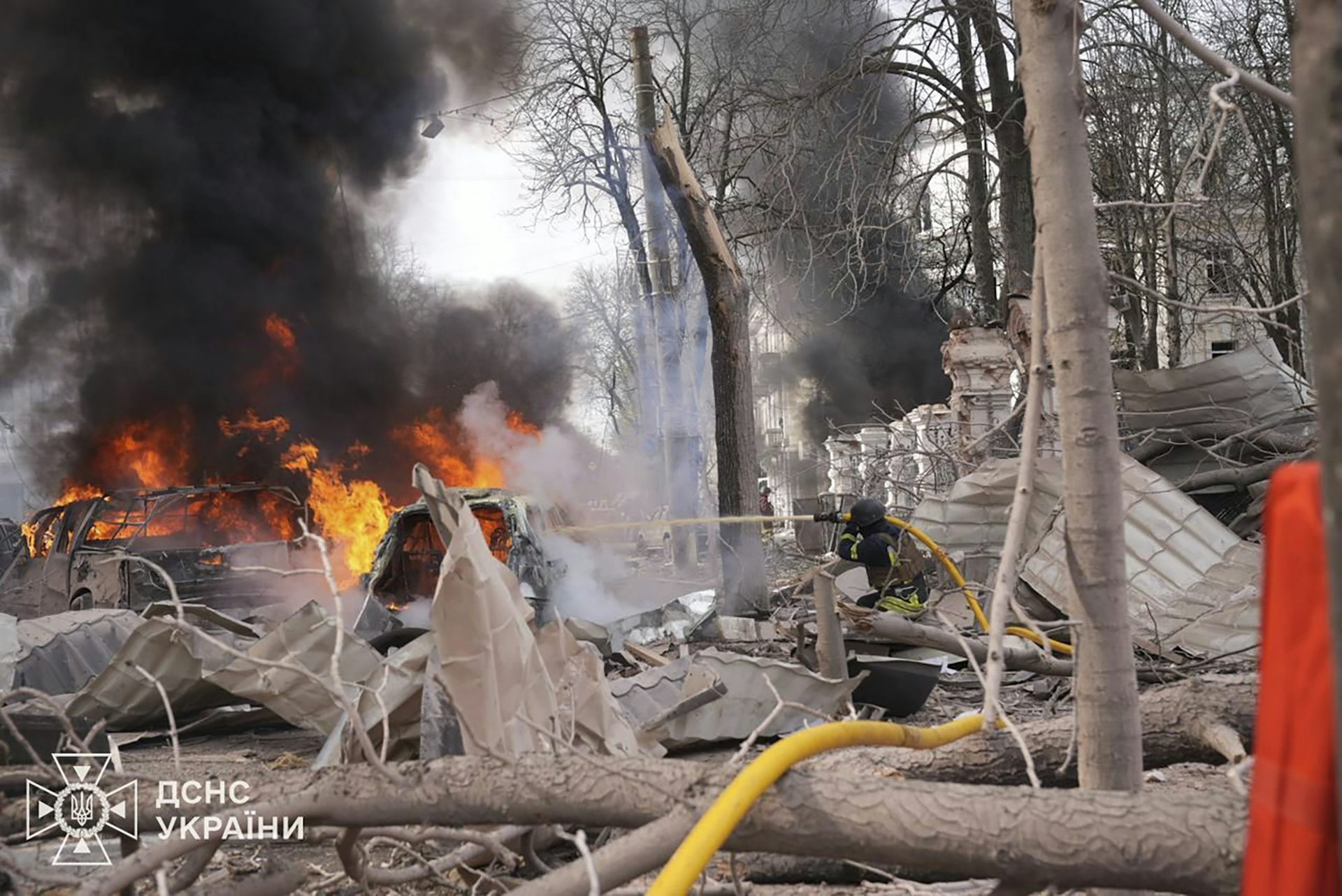 Rescue workers at the site of a rocket strike in Sumy, Ukraine.