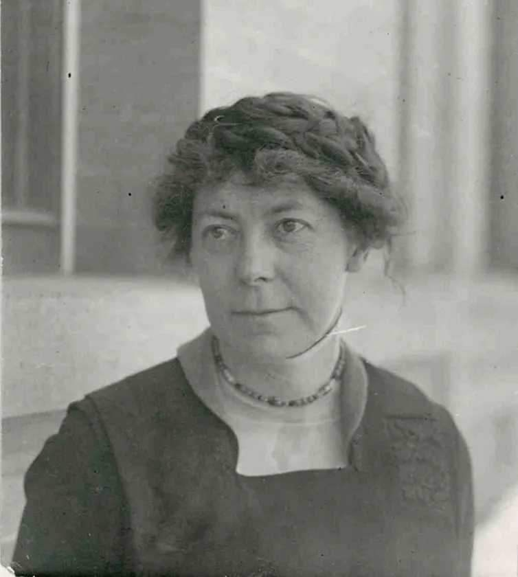 A sepia-toned photograph of Inga Allison, a white woman in dark clothes with her hair pulled back.