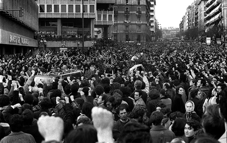 Spanish political transition: a a hit type? 3 A photo of the street full of people with their fists raised into the passage of funeral cars.