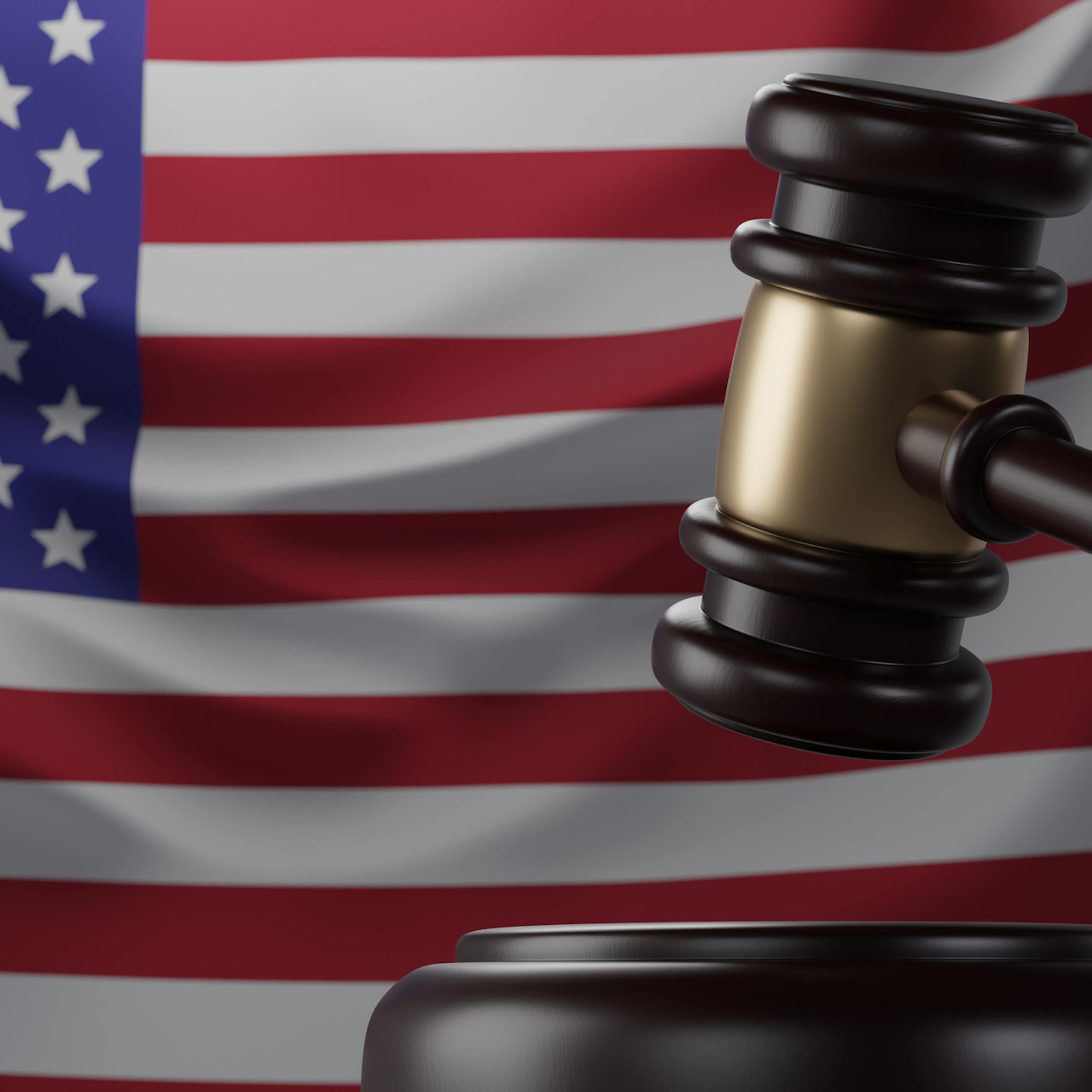 A US flag and a judge's gavel in front of it.