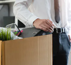 lawyer standing with box full of packed belongings