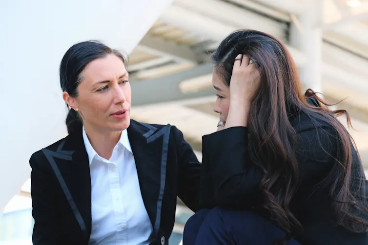 woman consoling her colleague
