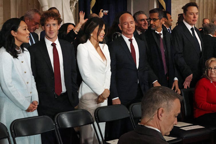 Besuited dressed business leaders at a formal event.