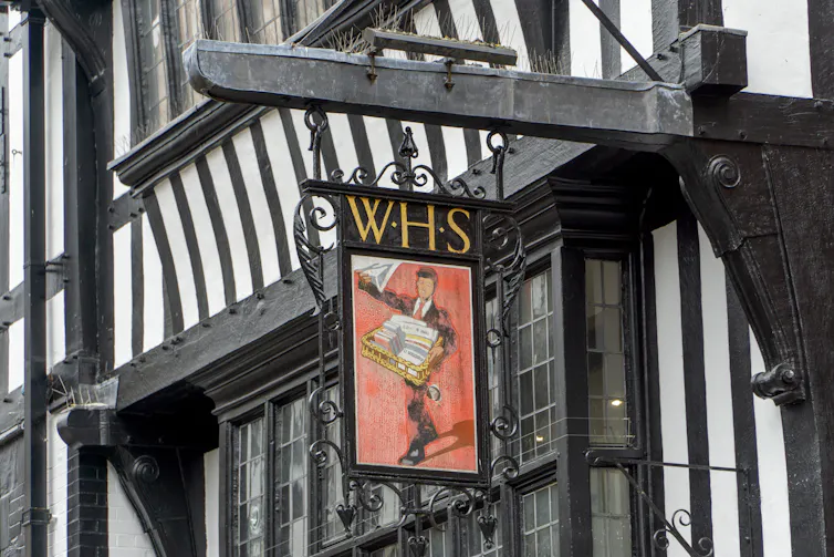 old whsmith sign hanging from a tudor building in chester